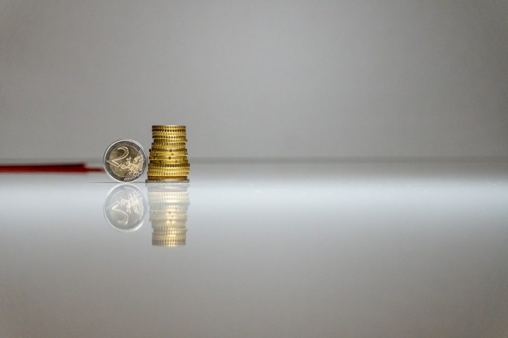 a-stack-of-coins-sitting-on-top-of-a-table-jpc-hiafzii